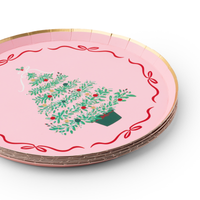 Holiday tablescape featuring Pink Christmas Tree dessert plates layered over plaid dinner plates with festive ribbon décor.