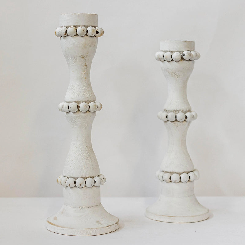 White wooden candle holders that are perfect to use as a centerpiece or throughout the home. These tall candlestick holders are perfect to gift to Mom for Mothers Day