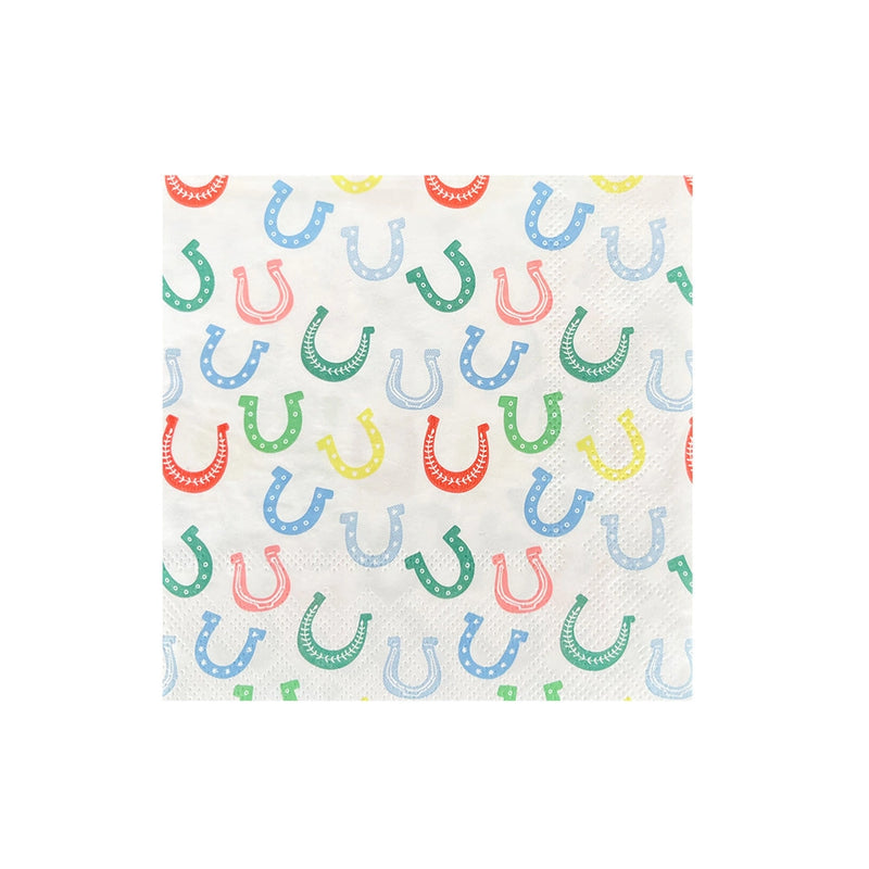 Product isolate: White cocktail napkin printed with scattered red, green, blue, and yellow horseshoes on a plain background.