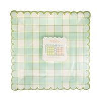 Retail packaging for 8ct paper plates featuring mixed pastel plaid designs, part of a festive spring table setting.