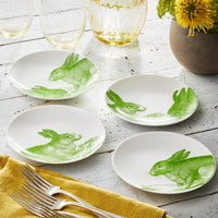 White ceramic appetizer plates with green bunny designs.