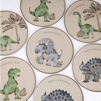 Assorted dinosaur plates spread across a white surface