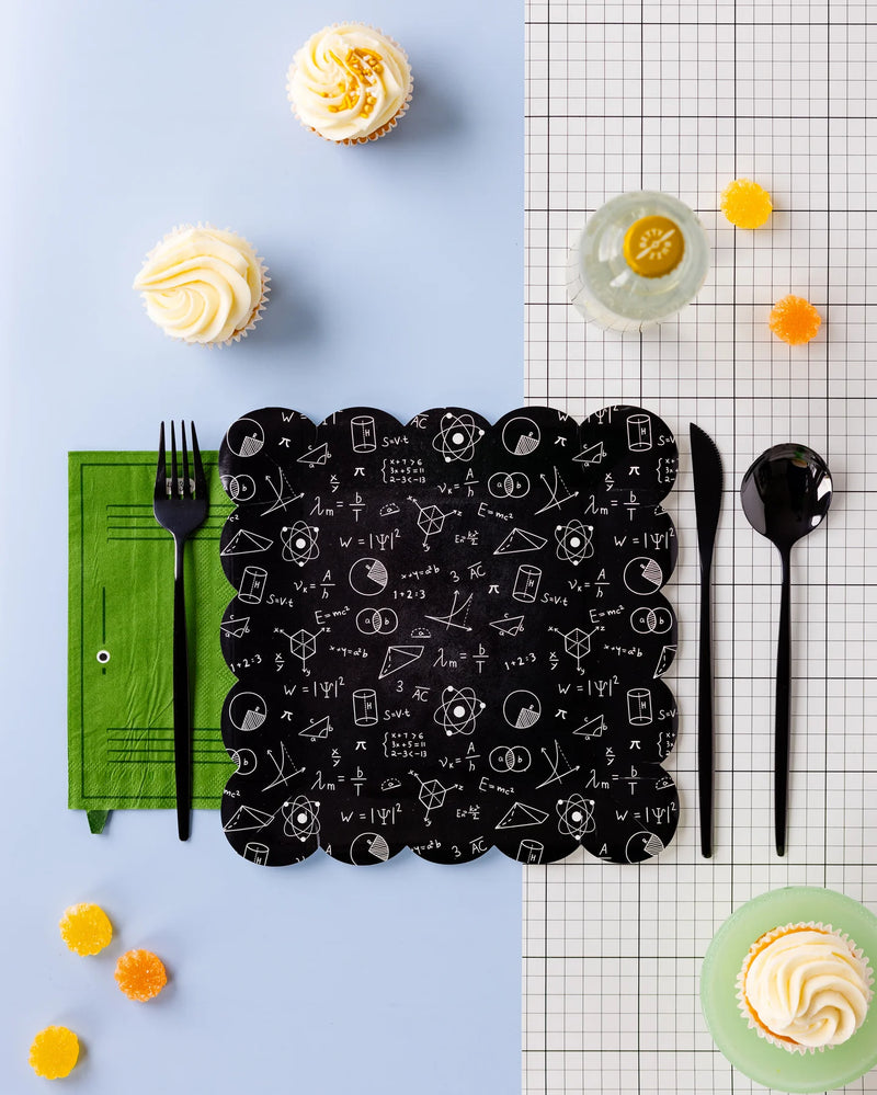Styled table setup with green locker napkin and school-themed blackboard plate surrounded by cupcakes and drinks.