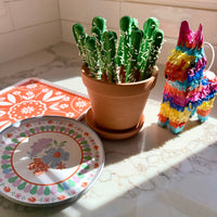 Cinco de Mayo party supplies with small pinata decor and cactus treat
