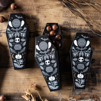 Group of Halloween Coffin Treat Boxes with spooky gold foil designs filled with chocolates.