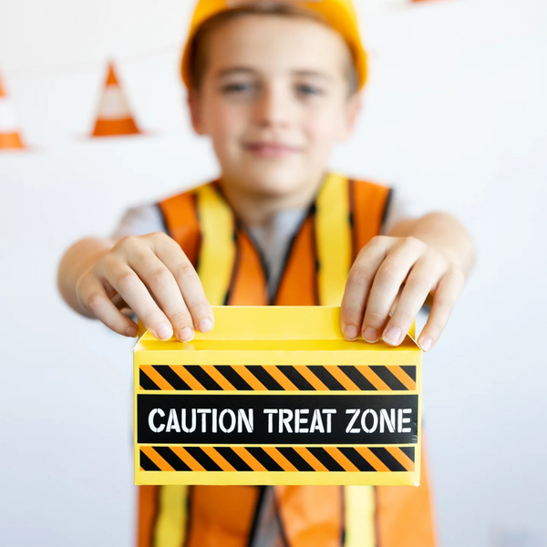 Another child displaying the treat box with both hands