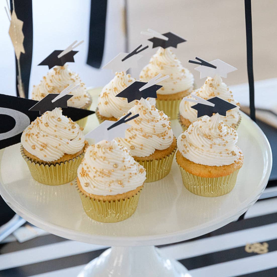 Cupcakes decorated with graduation hat cupcake toppers
