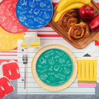 Close‑up school‑bus cup and red backpack napkin.