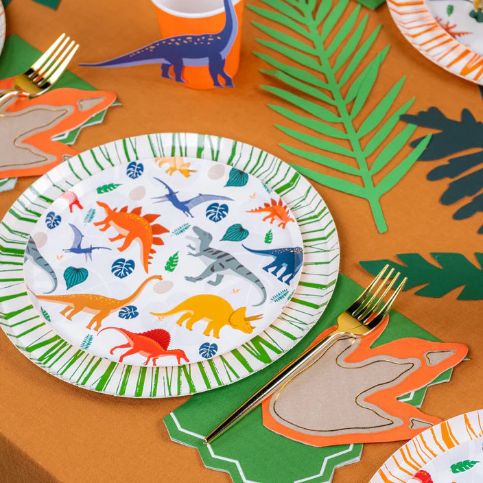 Dinosaur plate and leaves with footprint napkin at a place setting.