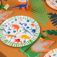 Dinosaur plate and leaves with footprint napkin at a place setting.