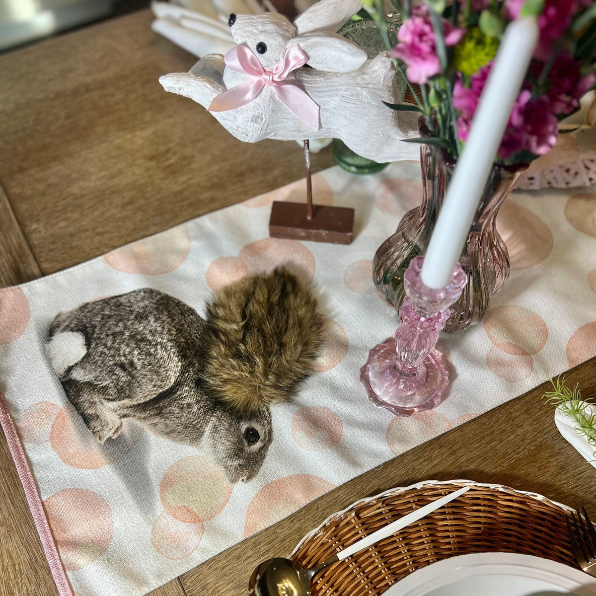 Easter table runner featuring pink polka dots and Easter Bunny design. Shown on an Easter Tablescape.