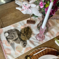 Easter table runner featuring pink polka dots and Easter Bunny design. Shown on an Easter Tablescape.