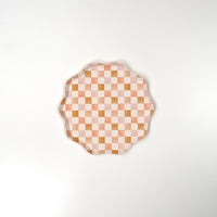 Peach and pink checkered dessert plate with a scalloped edge, featuring a watercolor-inspired gingham design. Perfect for brunches, baby showers, and stylish gatherings.