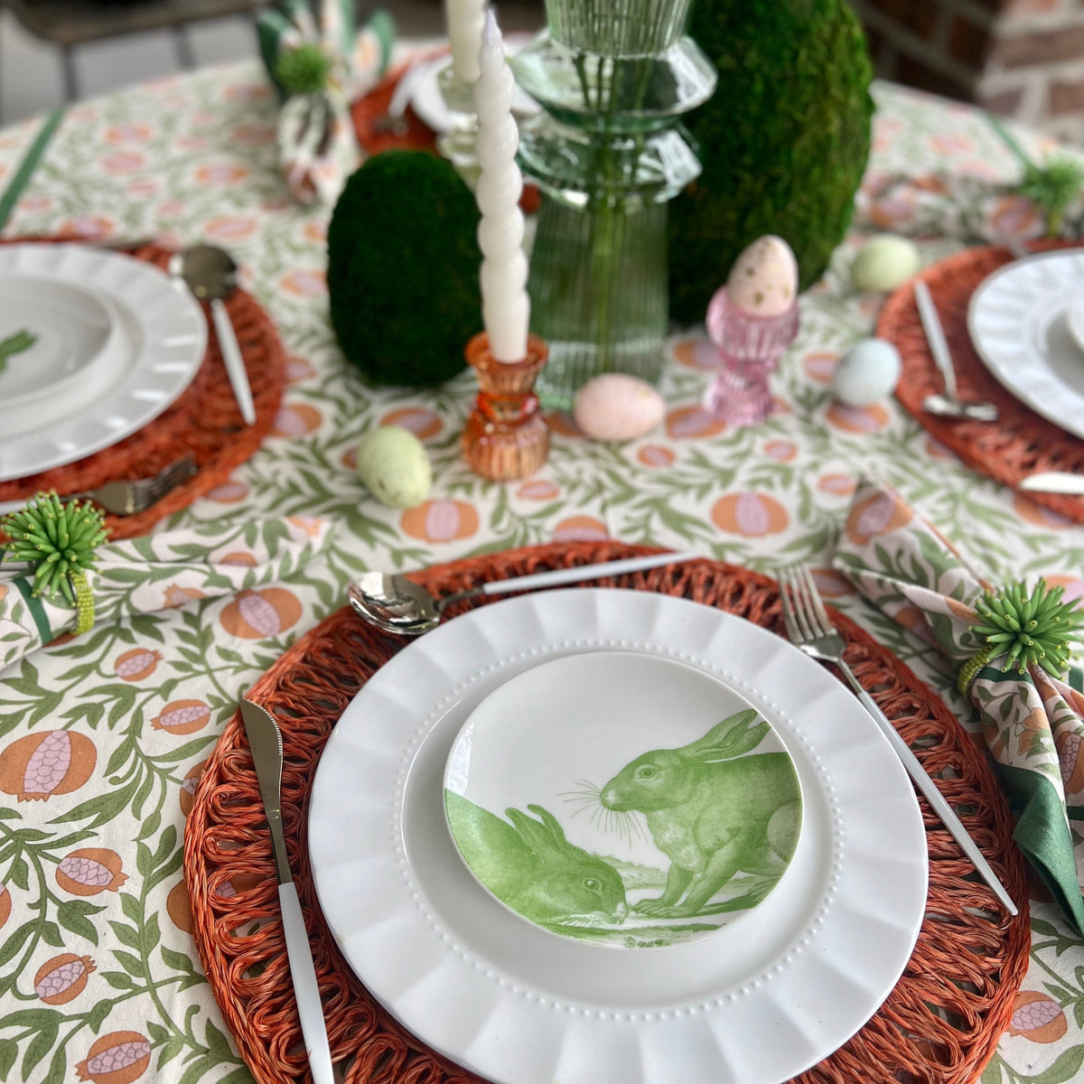 White ceramic appetizer plates with green bunny designs.