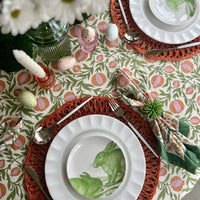 White ceramic appetizer plates with green bunny designs.
