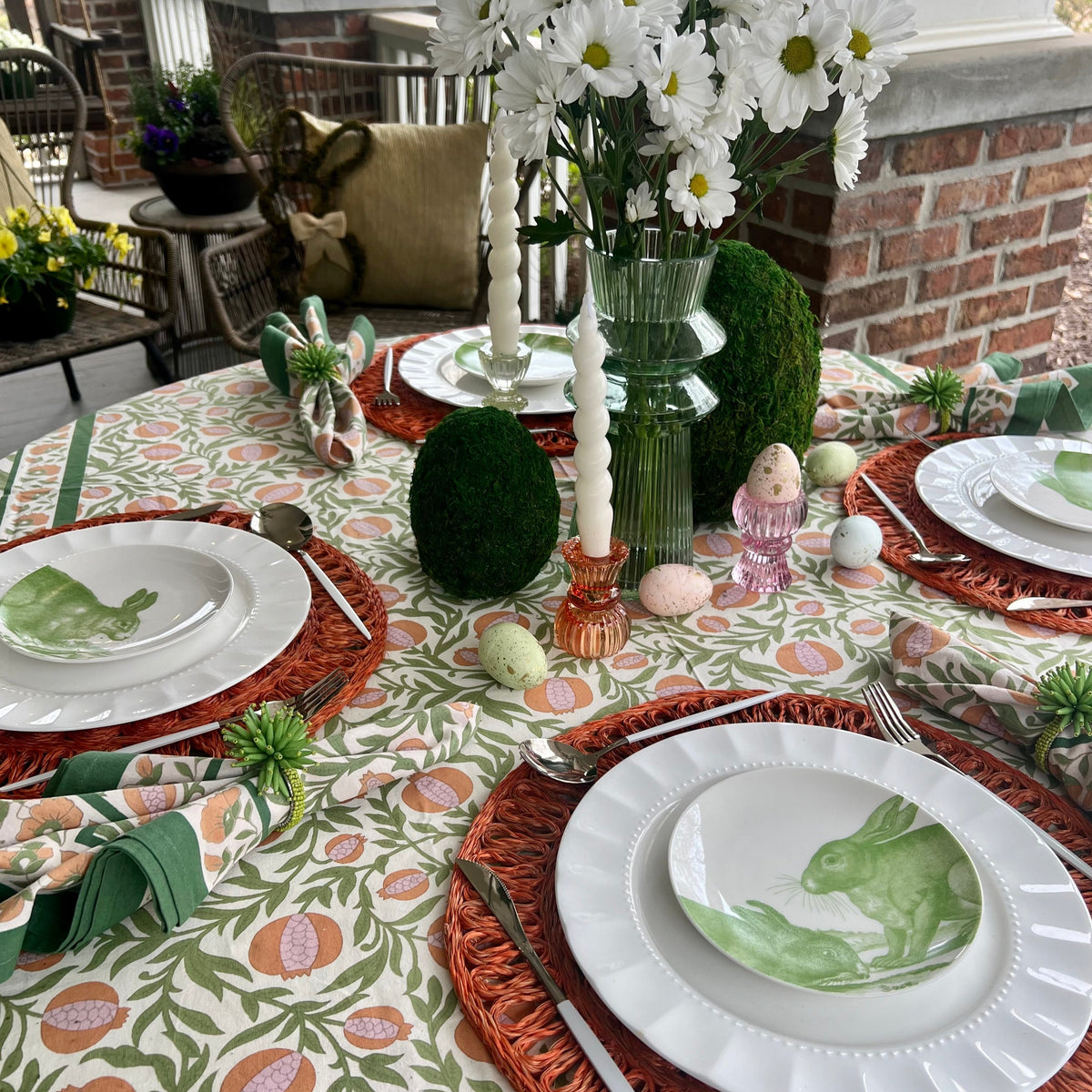 White ceramic appetizer plates with green bunny designs.