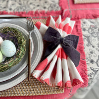 Gray velvet bow napkin ring on a spring napkin.