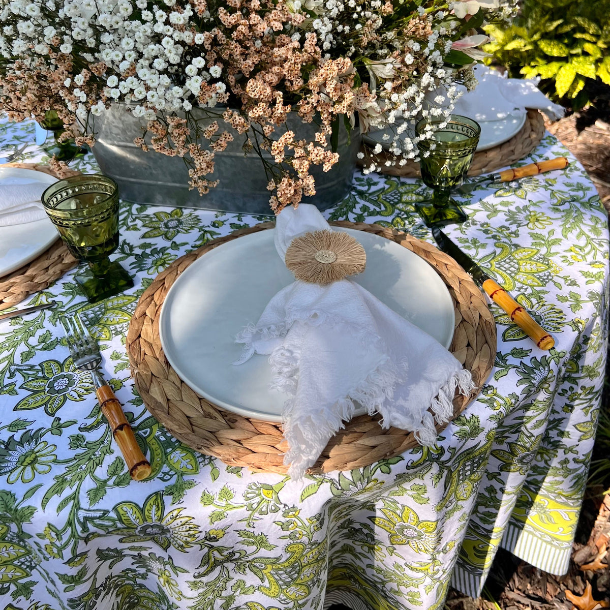 Discover the perfect backdrop for your summer celebrations with our Green Floral Tablecloth. Measuring 60"x 92", this tablecloth combines practicality with style, making it an essential addition to your garden party decor. Made from soft, durable cotton with a vibrant green and white block print, it’s not just a tablecloth—it’s a part of the party. Your guests will love this eye-catching floral tablecloth.