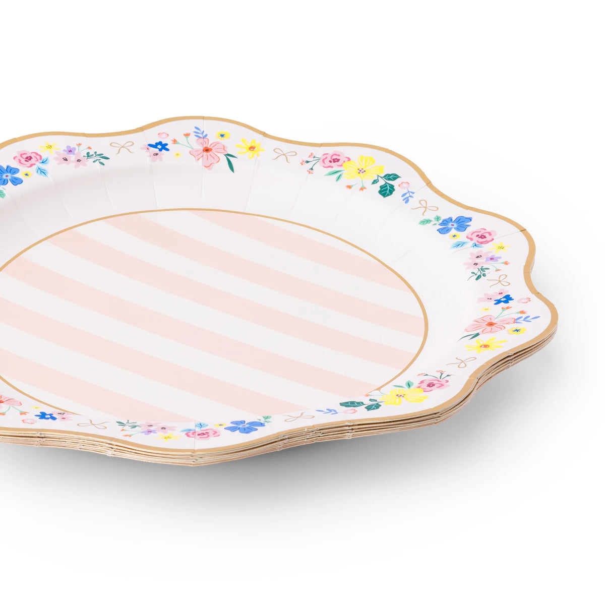 Angled stack of multicolor floral scalloped paper dinner plates with pink stripe center and gold foil rim on white background