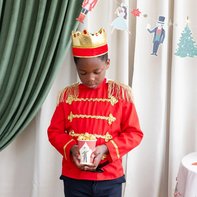 little boy holding a Nutcracker paper cup 