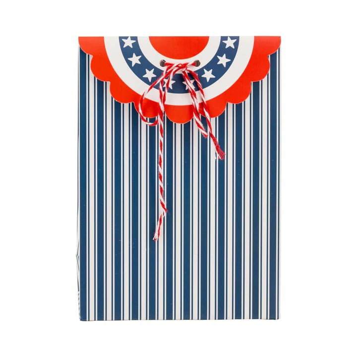 Patriotic bunting treat bag featuring navy stripes and a scalloped red, white, and blue flap, perfect for older children's party favors.