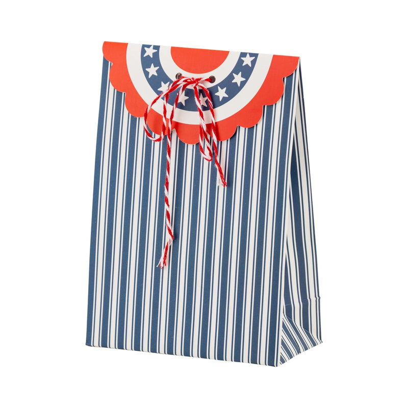 Blue-and-white striped bunting-style treat bag tied with red and white baker’s twine, ideal for a classy 4th of July party.