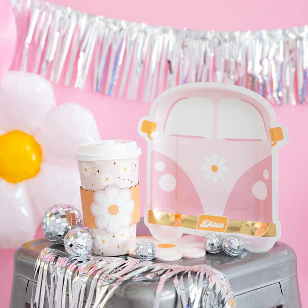 Close-up of disco daisy van plate on silver stool, surrounded by mini disco balls, daisy coffee cup, and sparkly fringe.