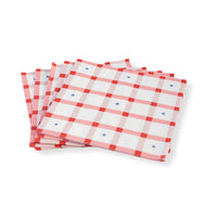 Stack of Red Gingham 4th of July Large Napkins set beside grilled foods and festive drinks.