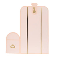 Close-up of a single blush pink treasure chest-shaped treat box accented with shiny gold foil detailing.