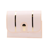 Assembled blush pink treasure chest treat box with elegant gold foil lock and stripe details.