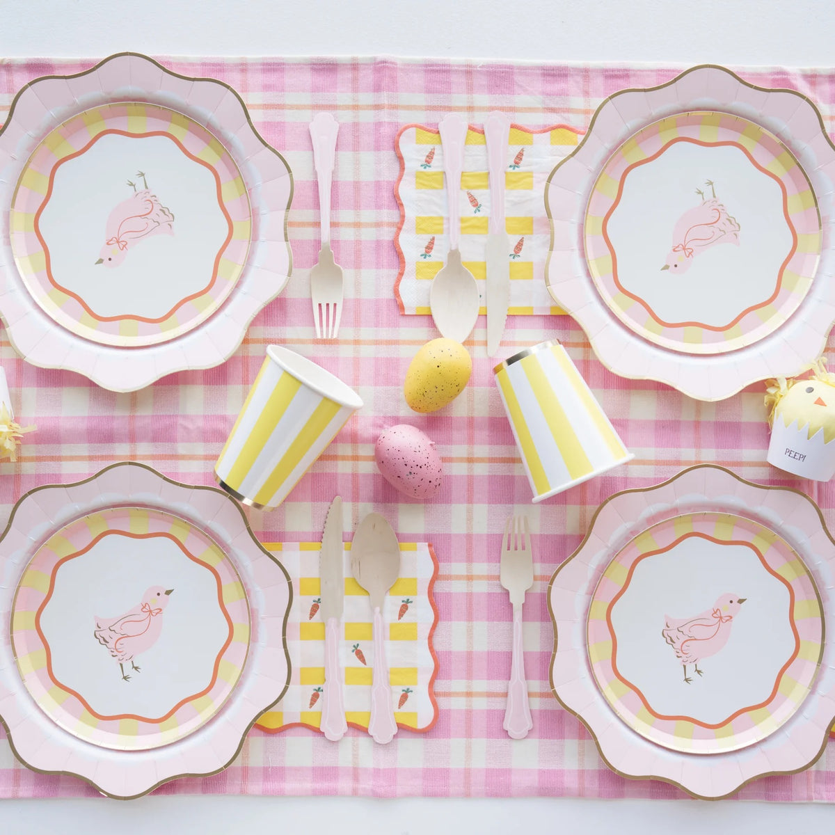 A beautifully styled Easter table featuring Sweet Carrot Easter napkins paired with matching pastel tableware, fresh florals, and festive decorations for a charming seasonal setup.