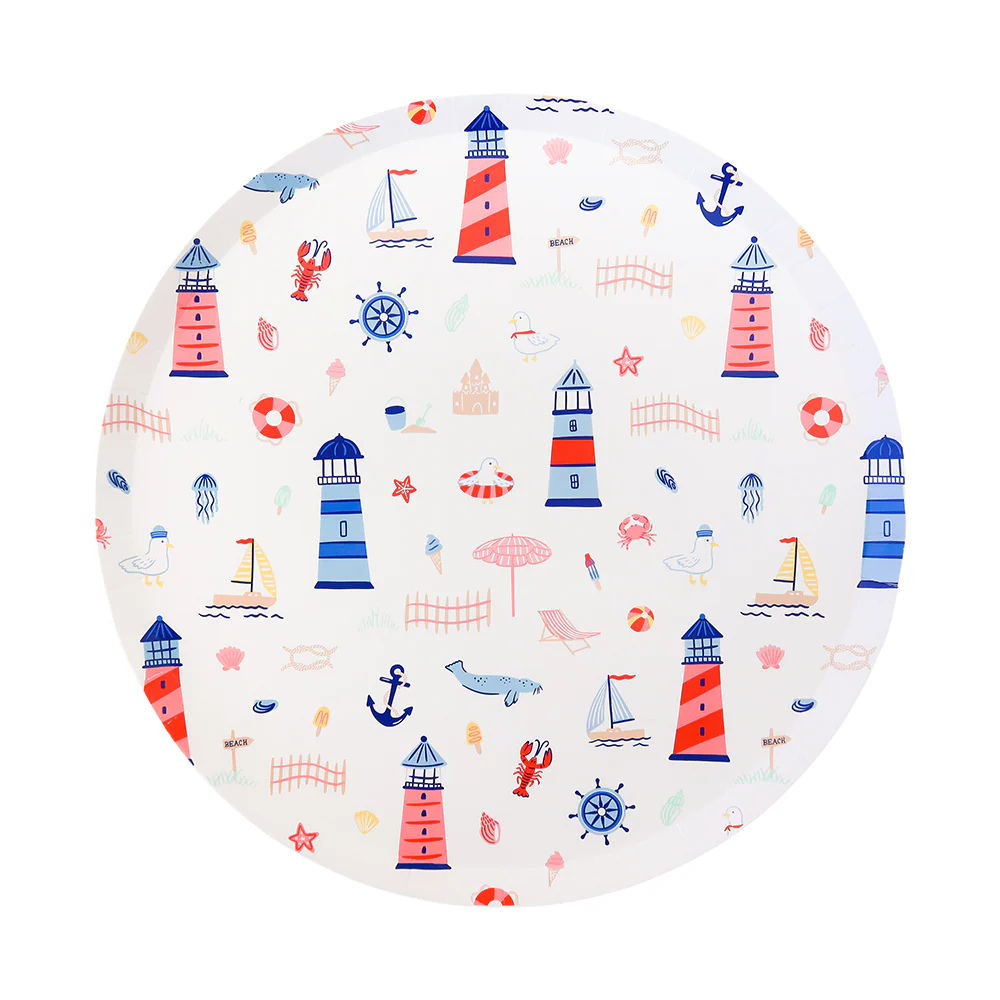 Round paper plate decorated with colorful seaside illustrations including red and blue lighthouses, sailboats, seagulls, jellyfish, anchors, and sandcastles.