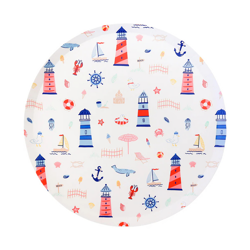 Round paper plate decorated with colorful seaside illustrations including red and blue lighthouses, sailboats, seagulls, jellyfish, anchors, and sandcastles.