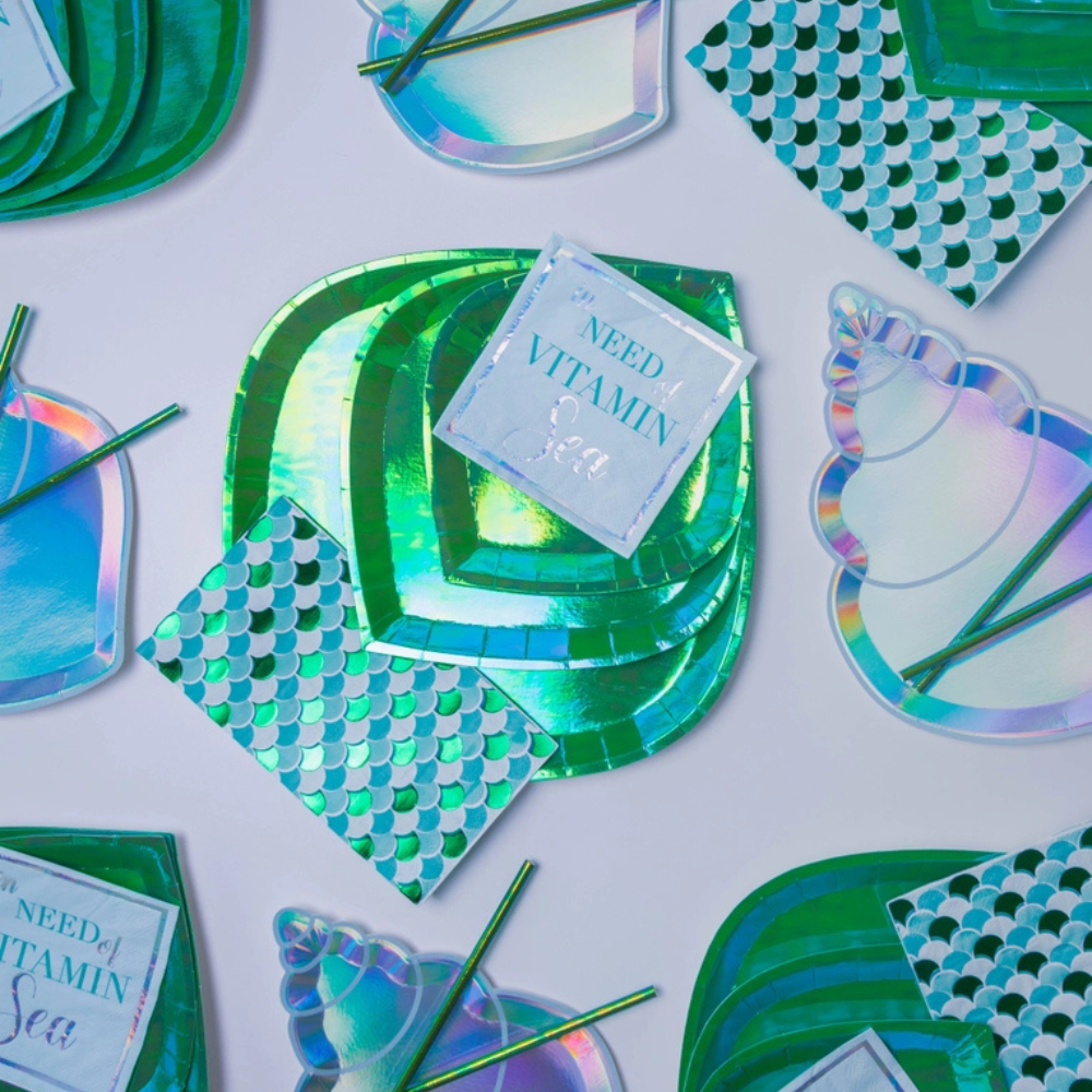 Shell Yeah Guest Napkins styled with iridescent seashell plates and green party supplies for a beach party.