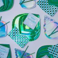 Shell Yeah Guest Napkins styled with iridescent seashell plates and green party supplies for a beach party.