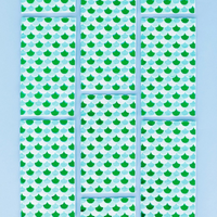 Arrangement of 16 Shell Yeah Guest Napkins in a grid, highlighting their aqua scale pattern with green foil.