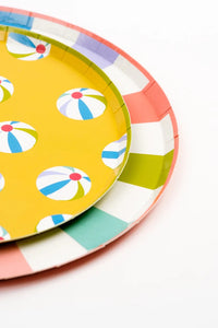 A detailed shot of the summer-themed dessert plates showing bold, tropical designs with beach umbrellas and beach balls, adding a fun touch to any summer gathering.