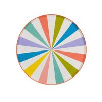 Close-up of a colorful striped plate with a bright summer design, perfect for a fun party.