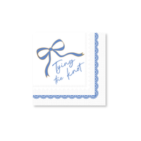Paper napkin with blue bow and 'Tying the Knot' text on a white background