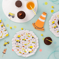 Styled party table featuring plates and napkins from the same collection, with decorated cupcakes.