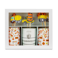 Close-up of boxed cupcake kit with toppers including trucks and traffic cones.