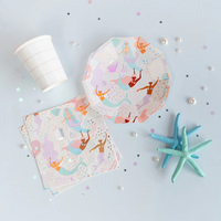 Flat lay of Under the Sea Large Napkins next to paper plates and cups with pearlescent finishes and pastel accessories.