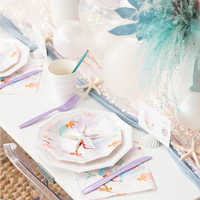 Pastel and pearl-accented tablescape featuring Under the Sea napkins, white cups, balloons, and a floral arrangement.