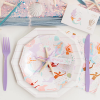 Close-up of pastel octagonal plates paired with mermaid napkins showing diverse mermaids and underwater illustrations.