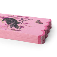 Pink Halloween paper placemats with scalloped edges and a black raven design.