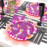 Angled place setting view highlighting the purple paper plate alongside a black plastic champagne flute on a striped table runner.