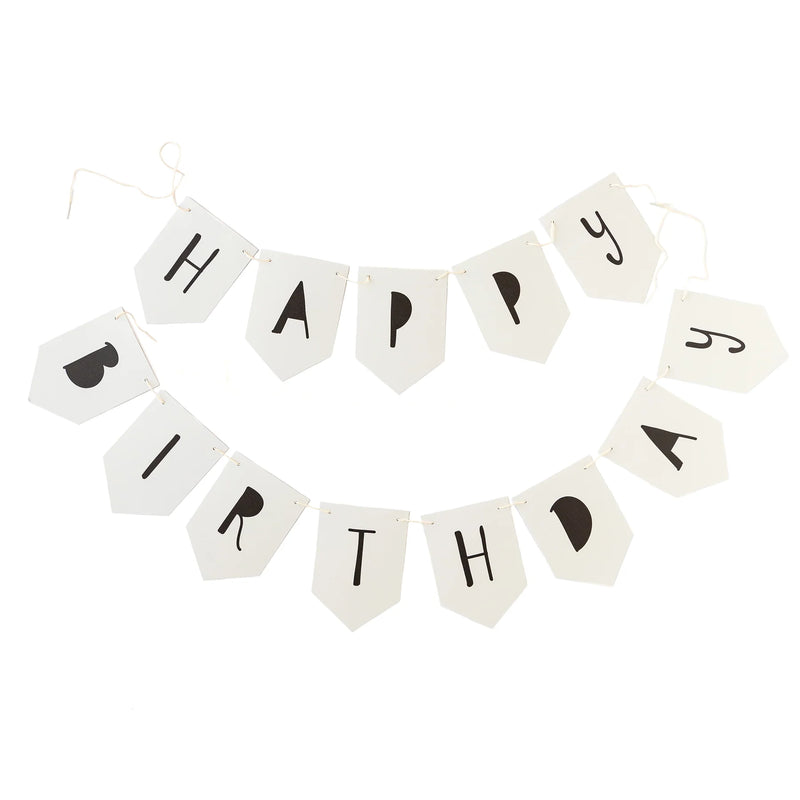 Unboxed “Happy Birthday” banner showing white pennants with playful black letters, laid out ready for stringing.
