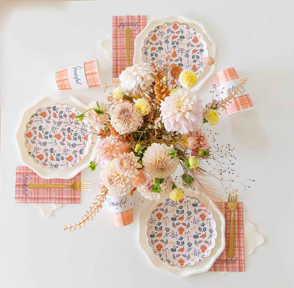 Dessert plate layered on white pumpkin-shaped plate with plaid “Grateful” napkin.