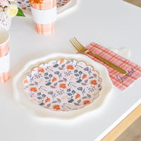 Dessert plate beside plaid cups on white table, ready for pie service.