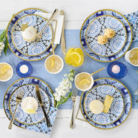 Mediterranean party table with blue tile dessert plates and summer drinks.
